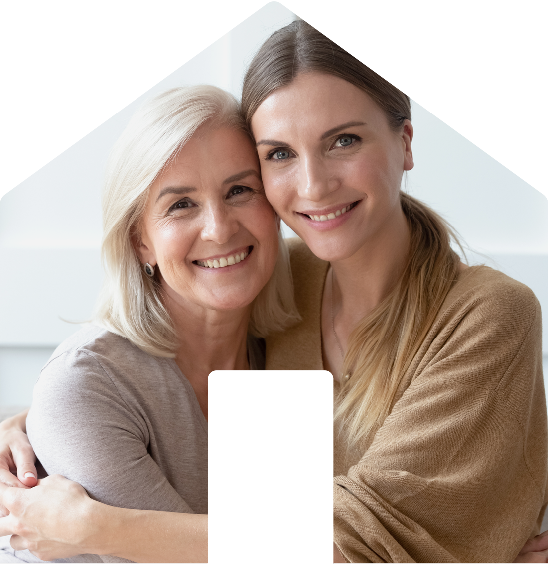 Mother and daughter hugging and smiling together in a bright room.