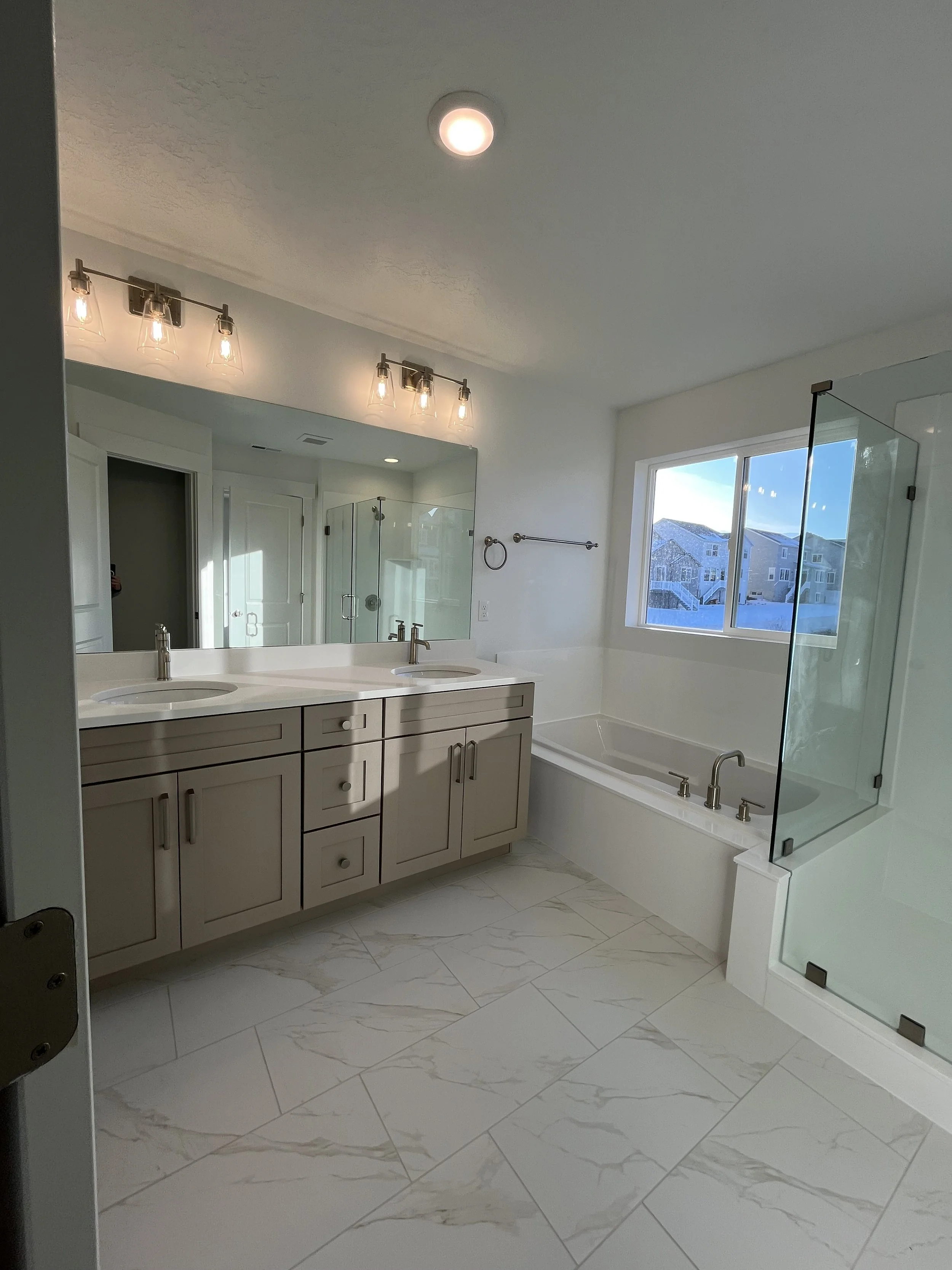 Finished open-concept bathroom with fantastic tiling work!