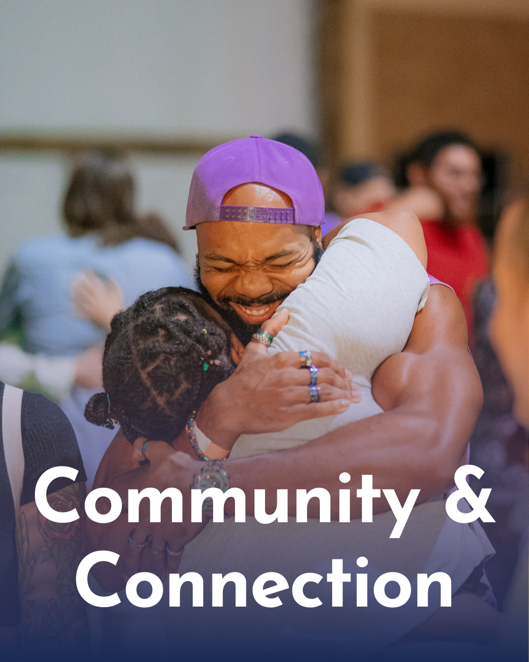 People hugging each other warmly at a community event, conveying connection and support.