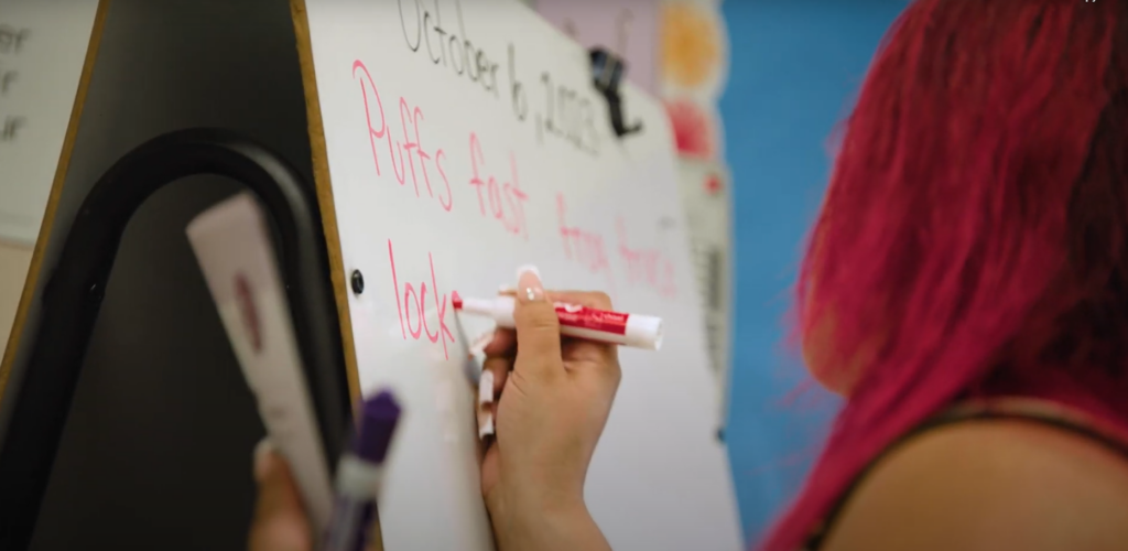 Woman writes on a whiteboard