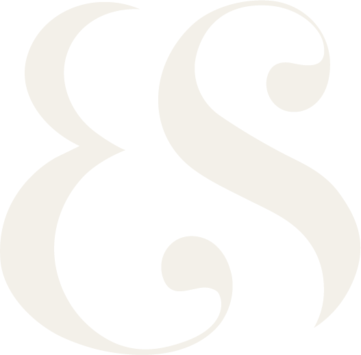 A stylized, large ampersand symbol in white on a black background.