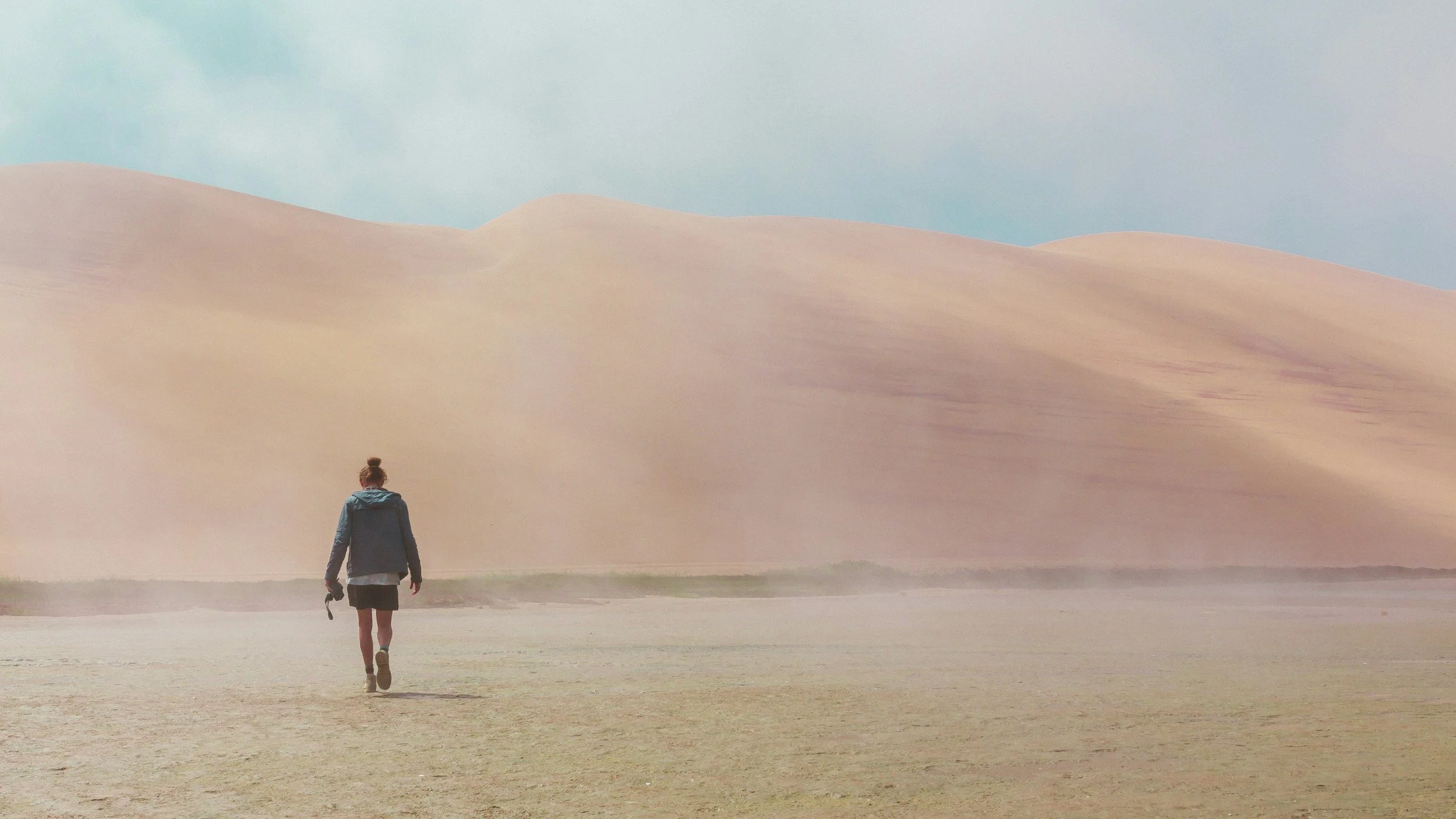 Woman walking through a desert landscape, representing trauma therapy and healing through EMDR therapy.