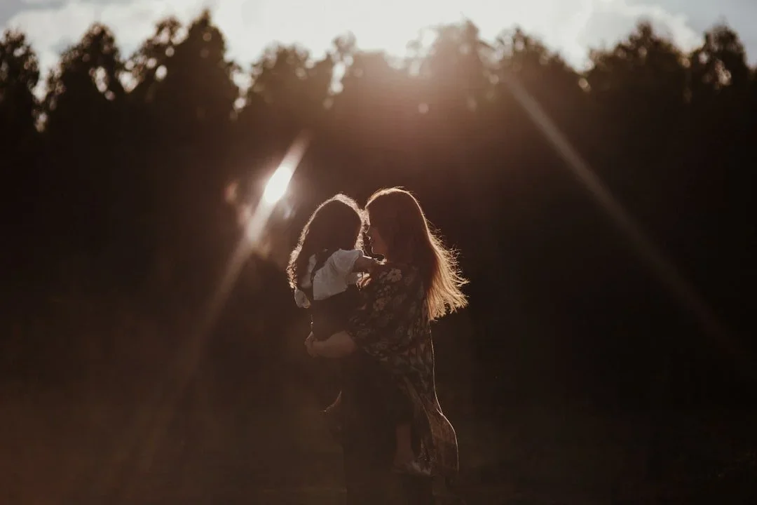 Mother and young child outdoors representing healing from birth trauma years after the birth