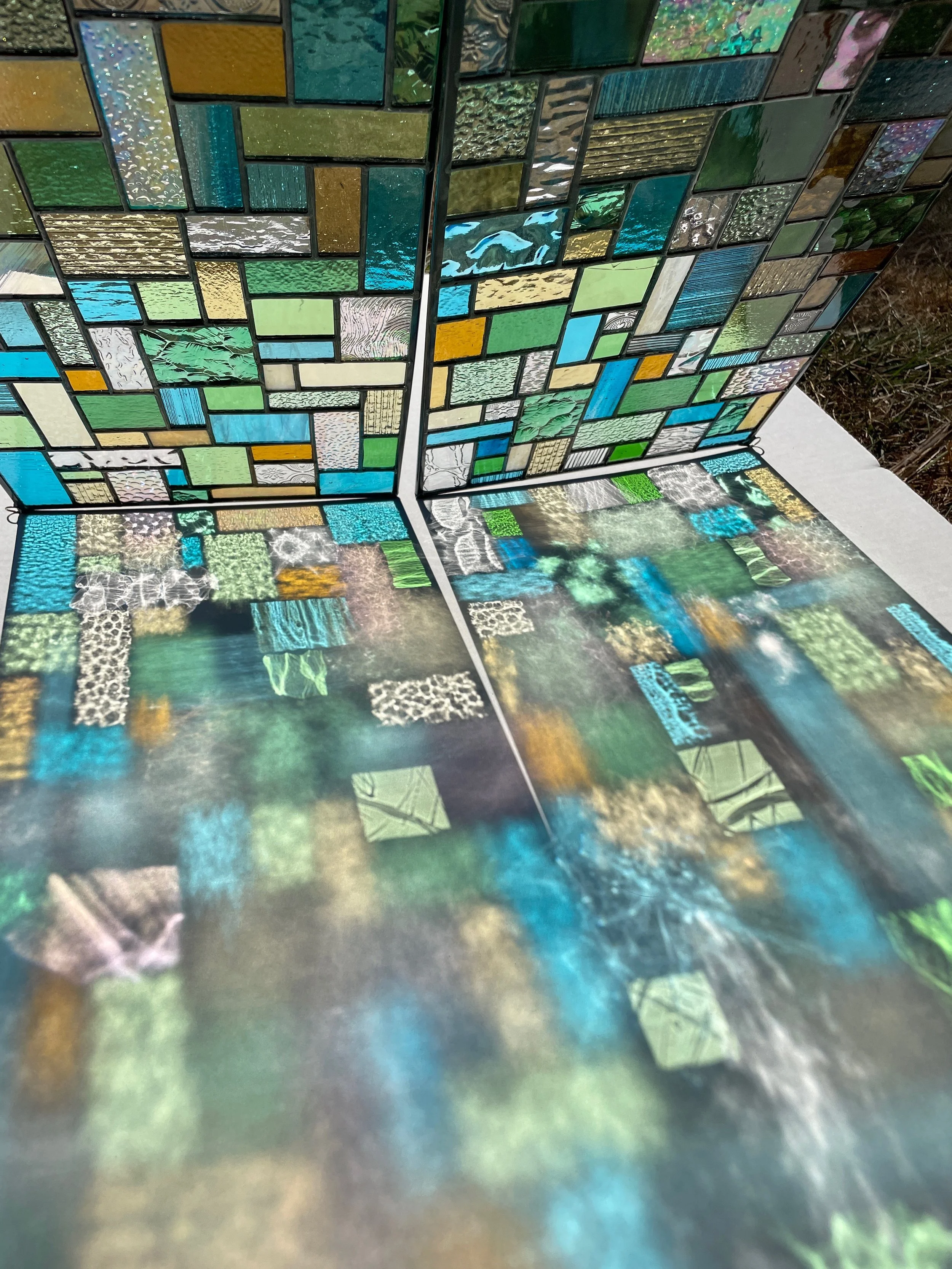 Colorful mosaic tiles with varying shapes and textures, reflecting light and creating a vibrant pattern.