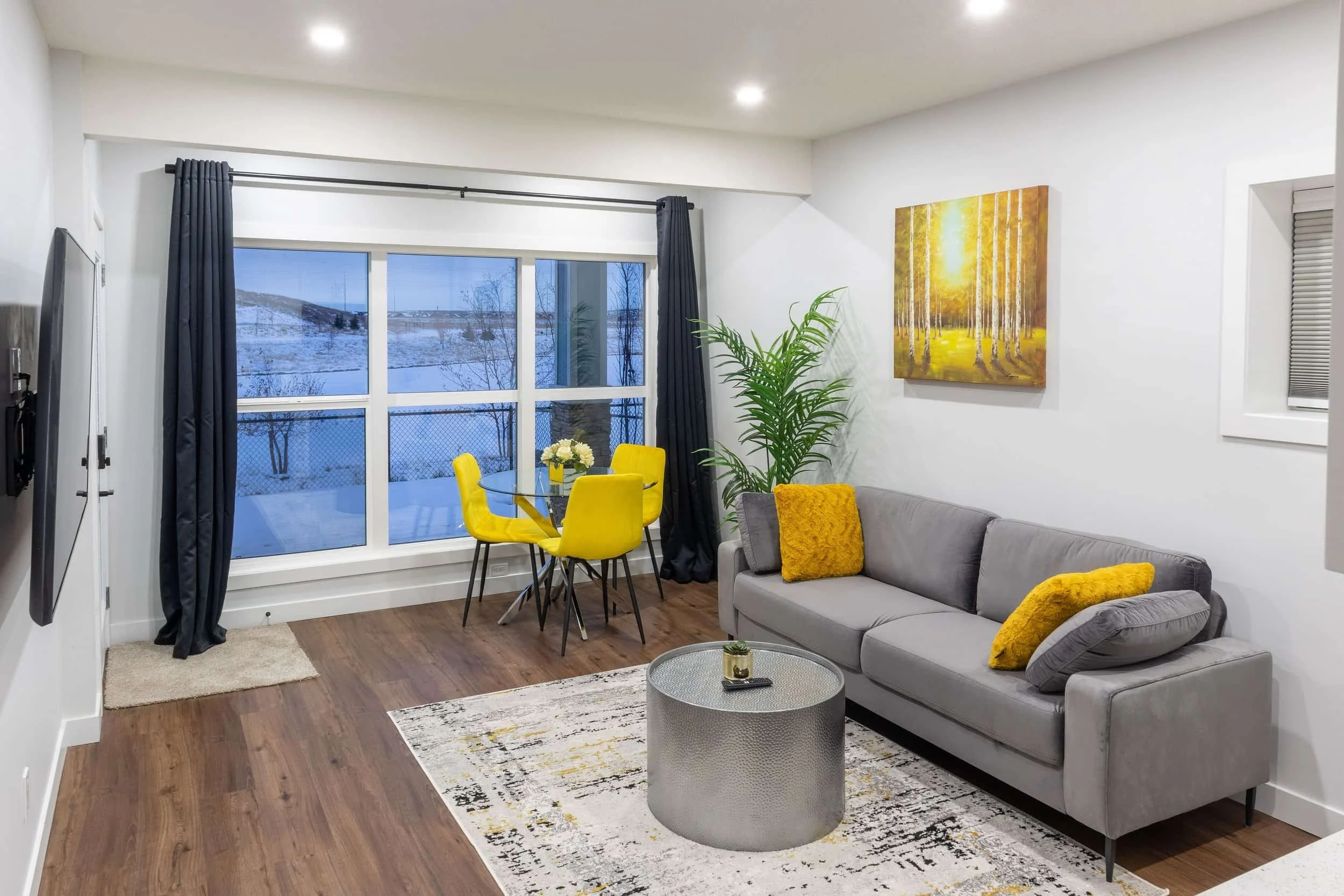 yellow-velvet-dining-chairs-grey-sofa-silver-drum-table-snowy-window_compressed.jpg