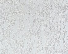 Close up image of a white knockdown ceiling texture showing the mottled drywall finish and subtle raised patterns under even lighting.