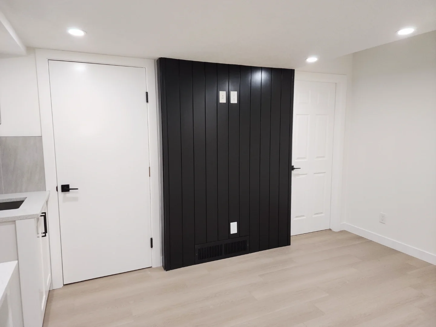black-slat-feature-wall-basement-living-room.webp