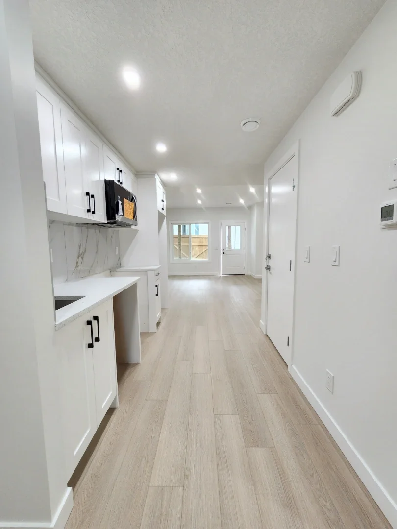bright-kitchen-hallway-with-white-cabinets.webp