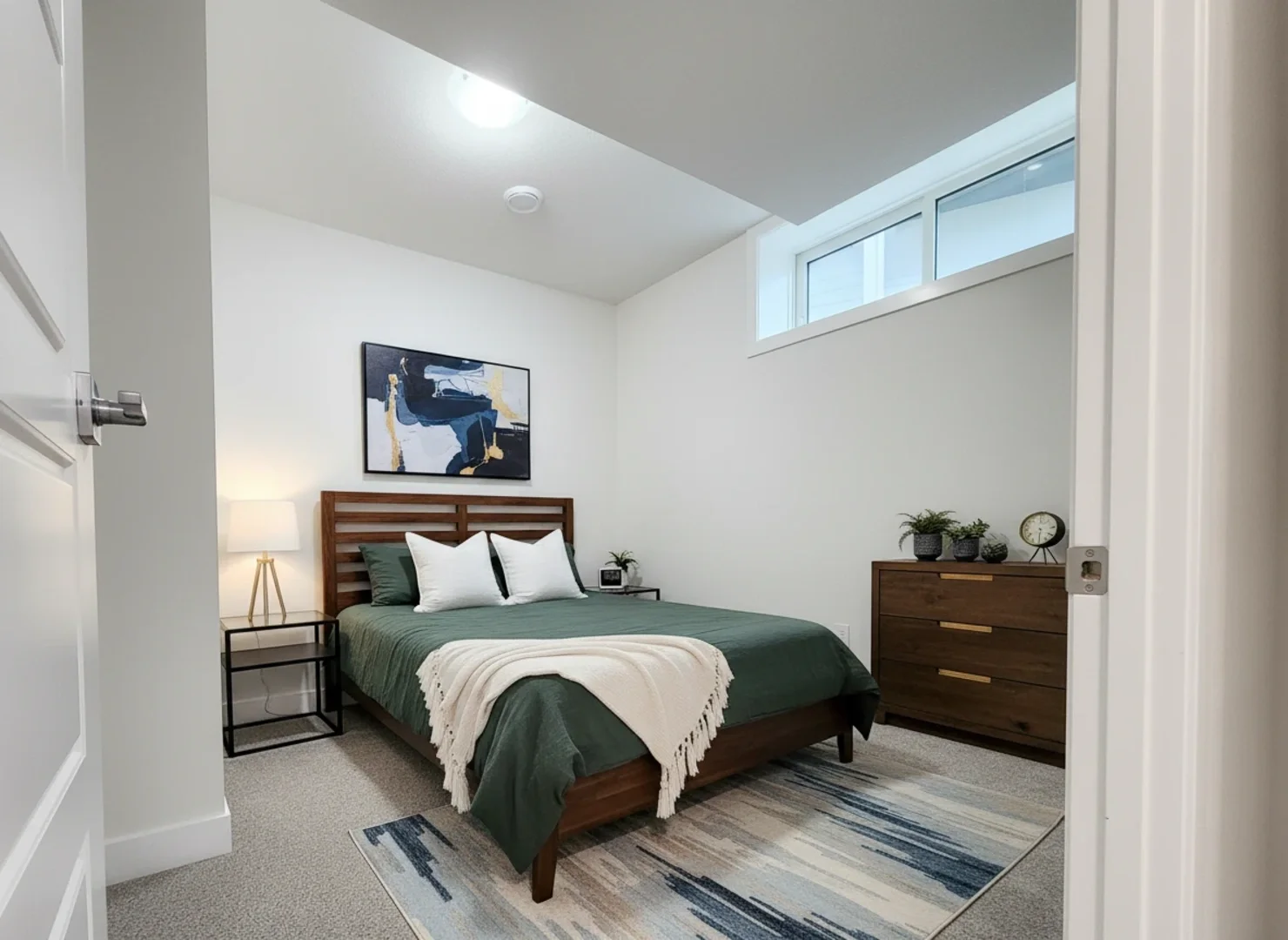 A stylish bedroom featuring a wooden slat headboard, deep green bedding, and a mid-century modern style wooden dresser.