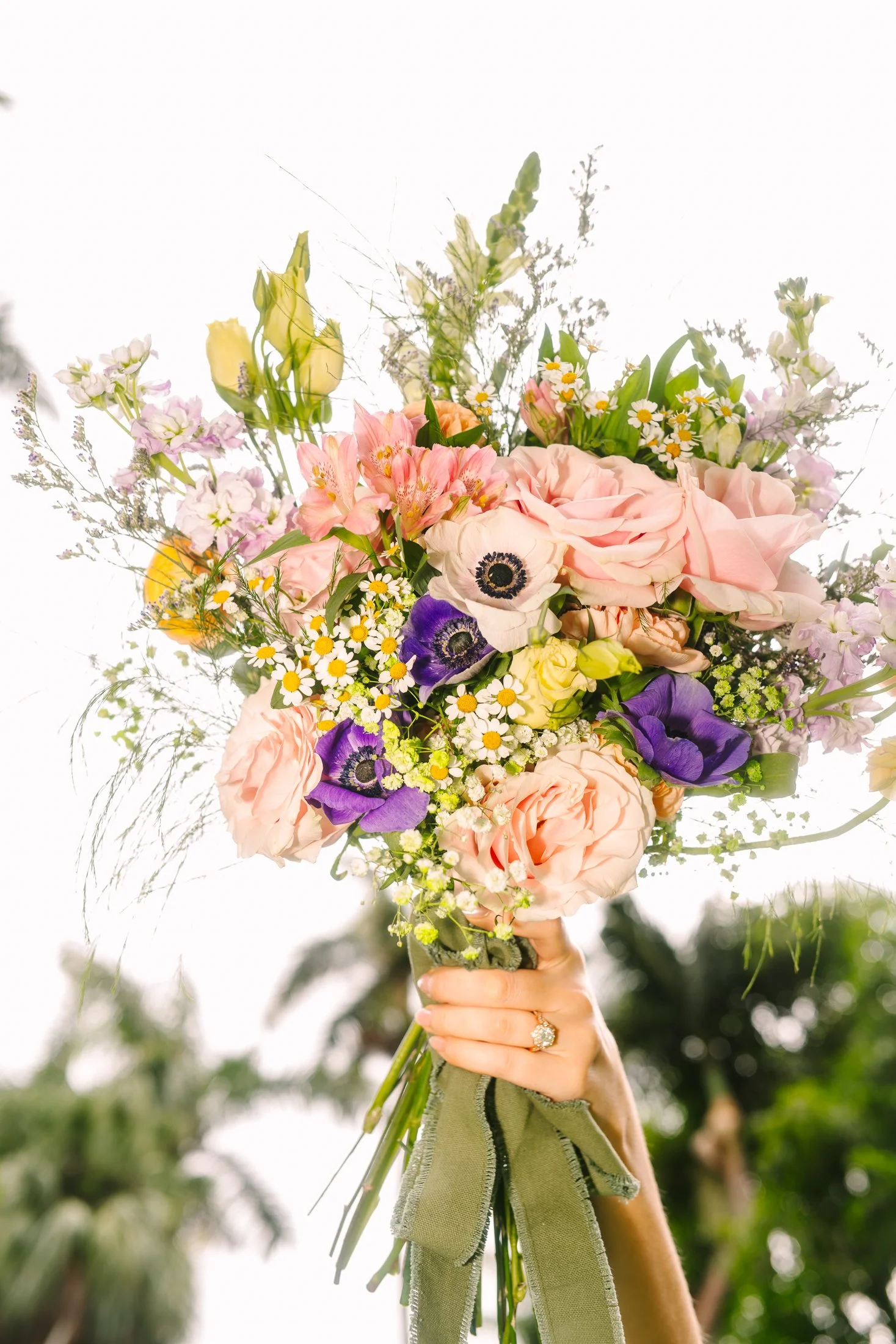 colorful wedding bouquet with purples, pinks and yellows at sunken gardens in st. pete, florida