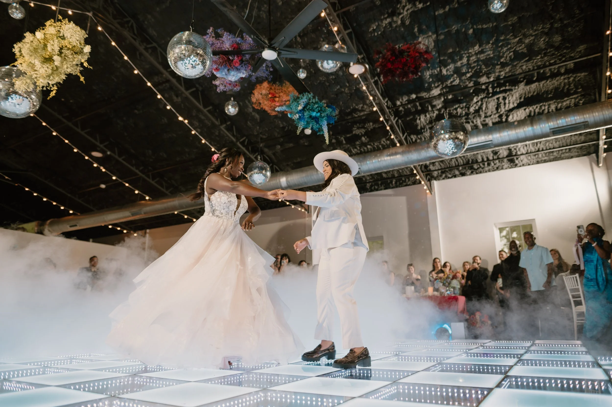 same sex couple on dance floor at secret garden at paradise spring wedding reception