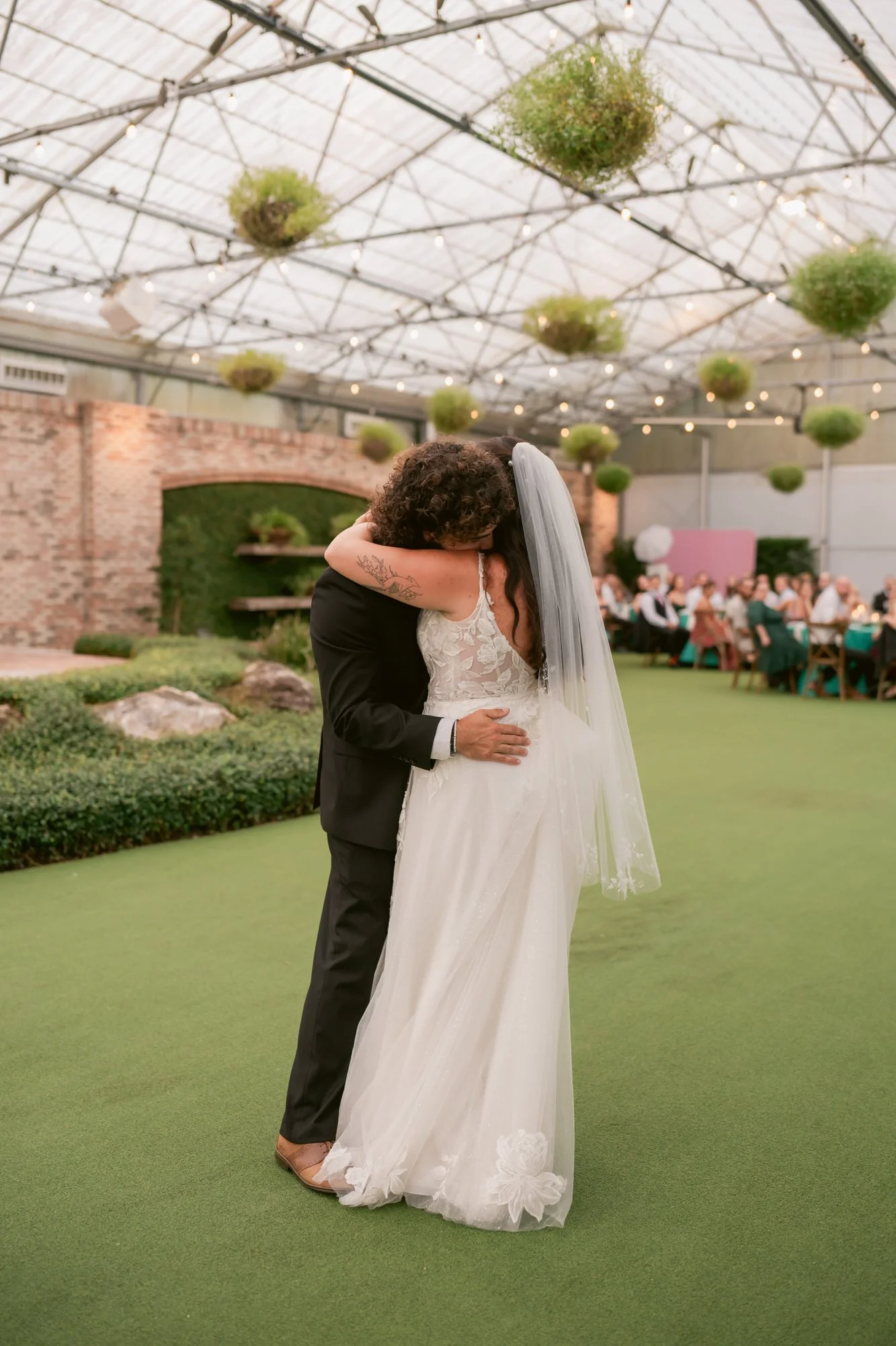 couple embracing during first dance at hardeman's secret garden wedding