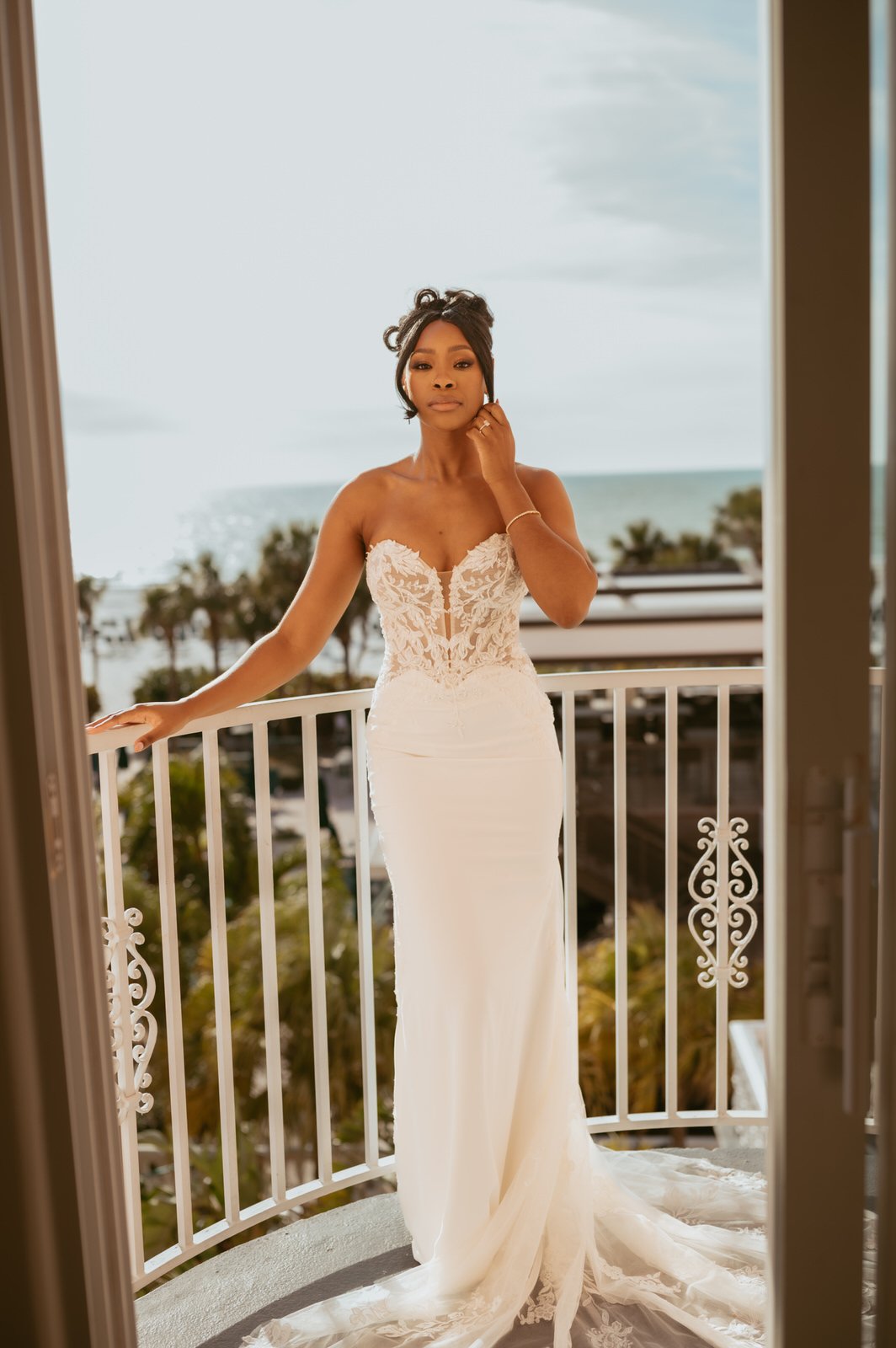 black bride in gorgeous mermaid wedding gown with illusion top on balcony at don cesar hotel