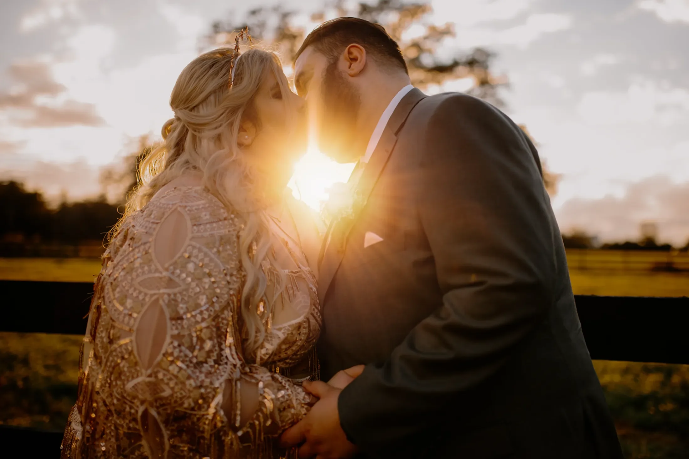 tampa wedding with couple bride in gold and champagne dress kissing at legacy lane weddings