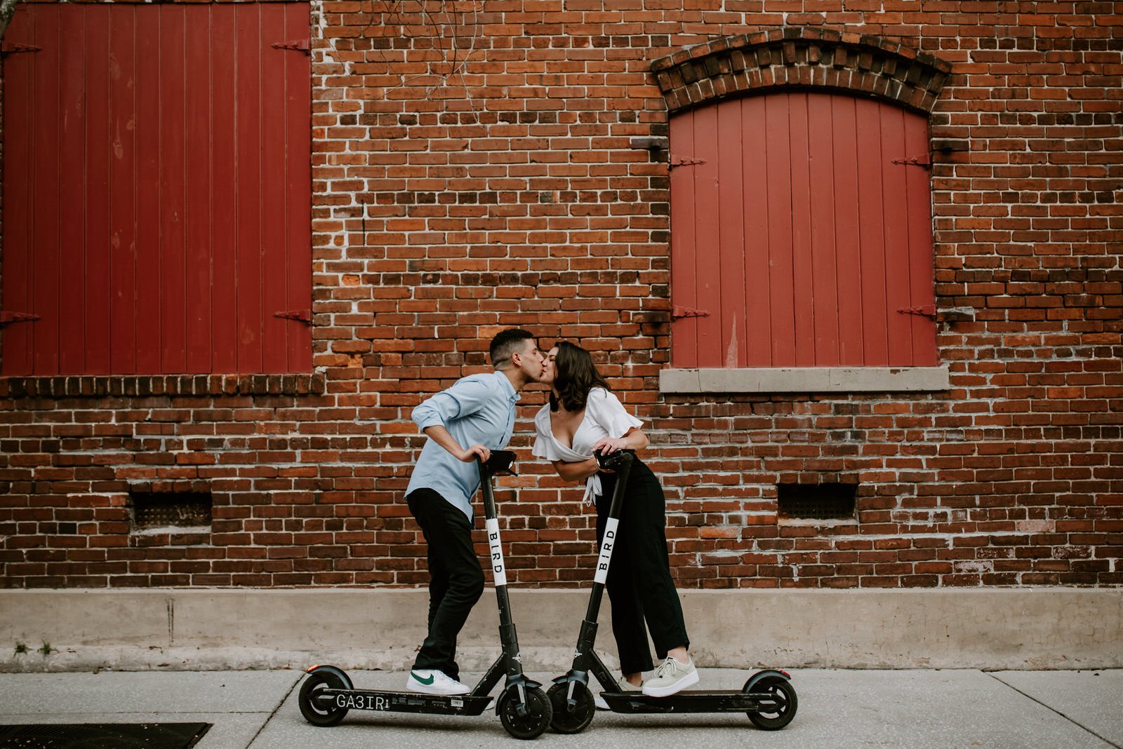 engagement photos of a couple in Ybor Tampa on scooters