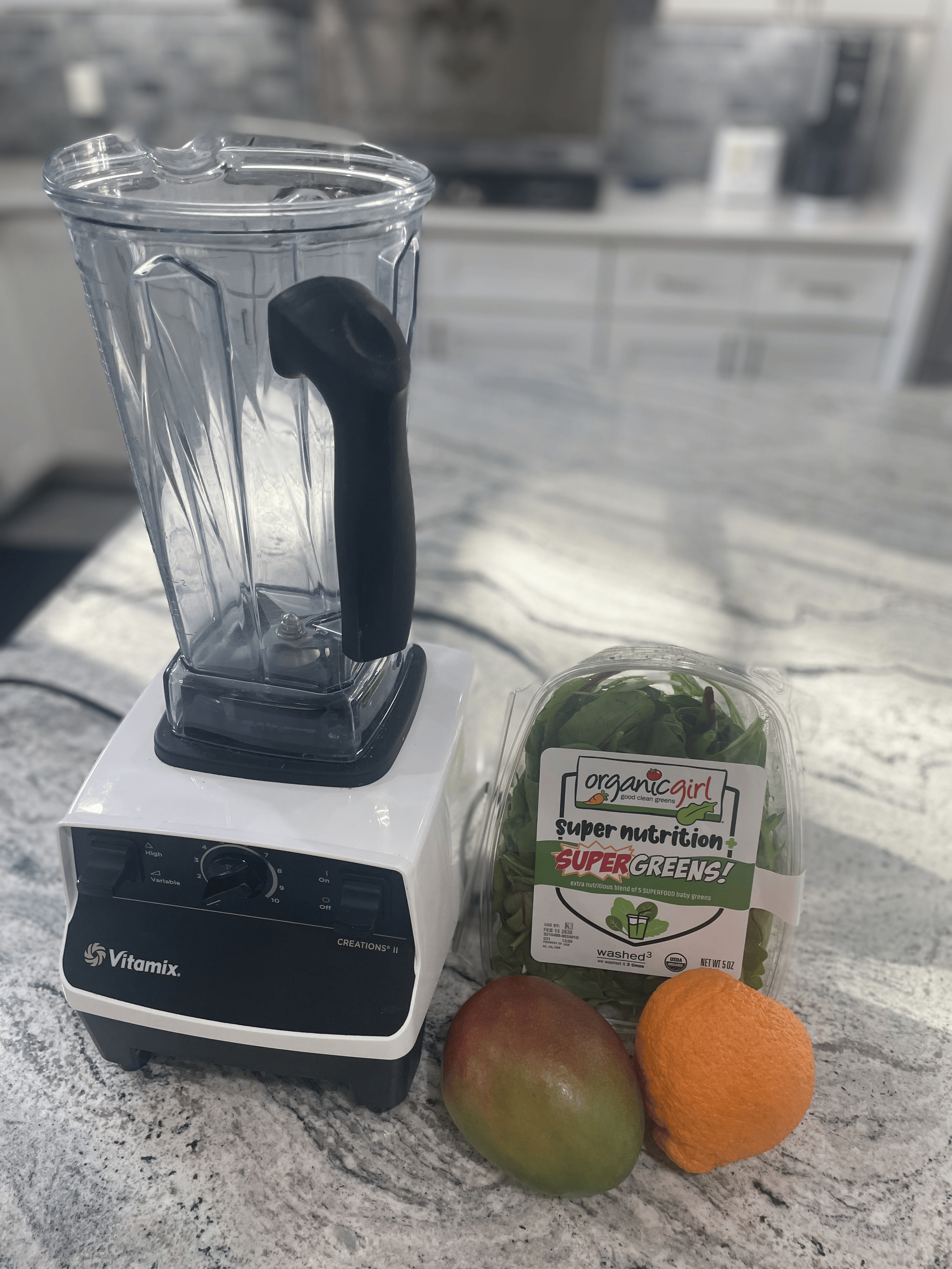 vitamix blender with Spinach, mango, banana, orange and milk for easy kids smoothie
