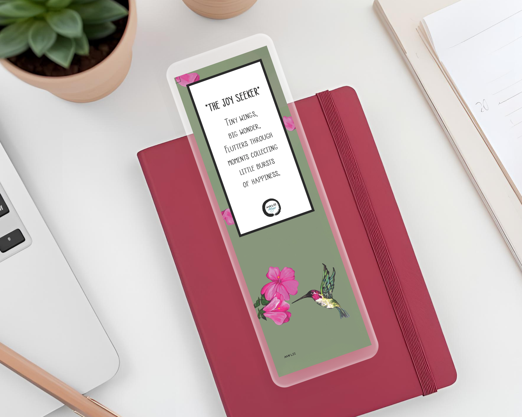 Hummingbird_Visionary_Bookmark  on dark pink journal Mockup.png