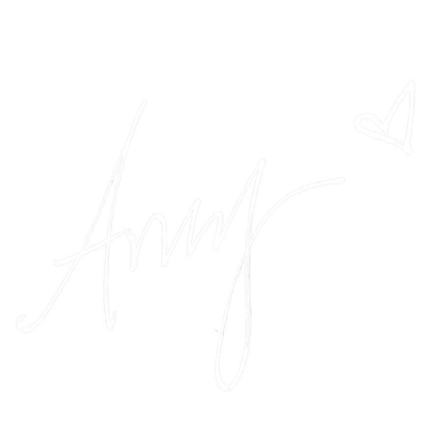 White handwritten signature with a heart and checkmark on a black background.