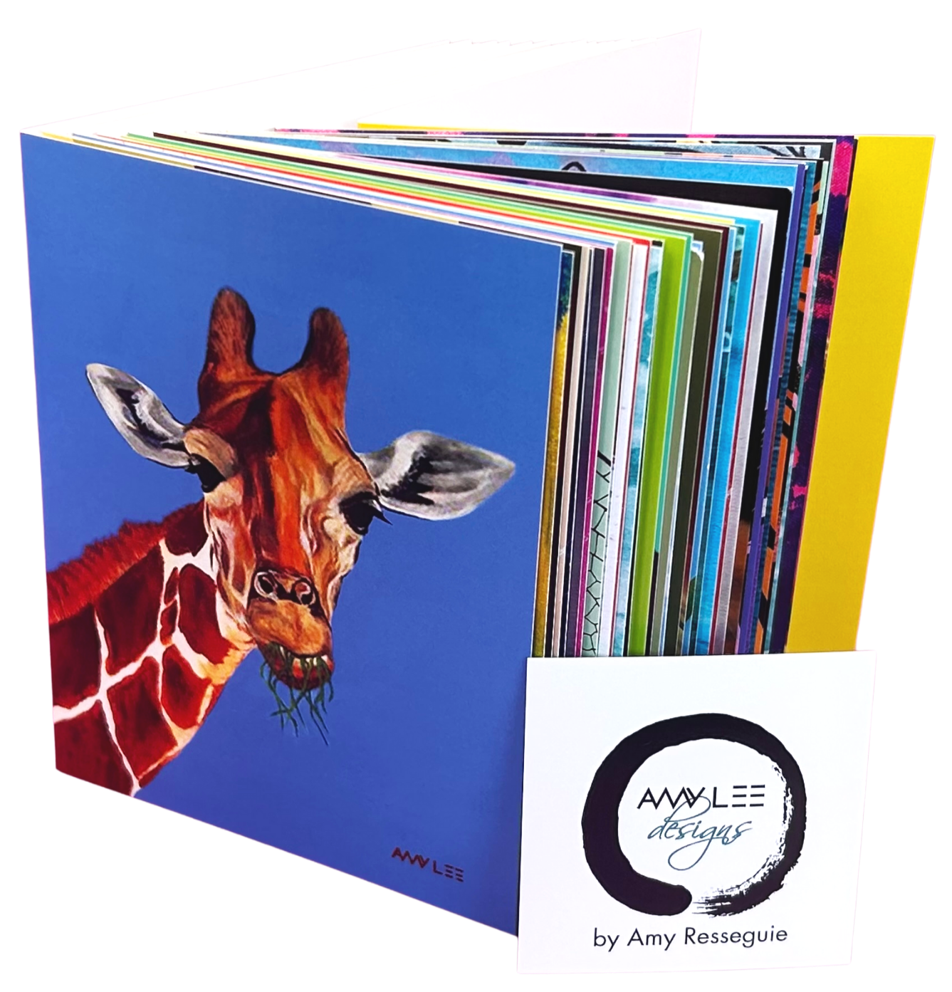Open portfolio with colorful pages and a front cover featuring a painted giraffe against a blue background, and a white card with 'AMY LEE designs by Amy Resseguie' logo.