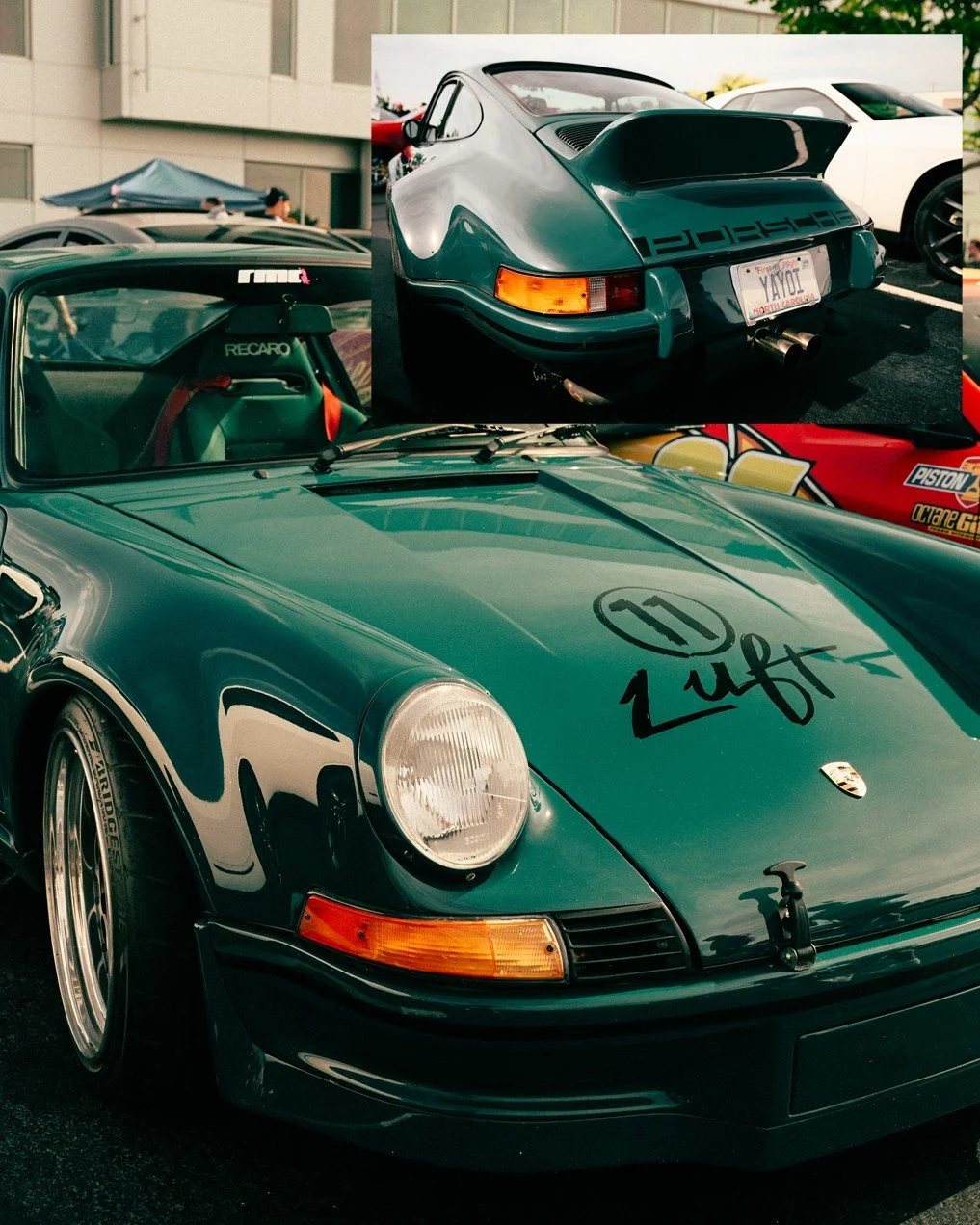 A green Porsche 911 with a custom hood that says "Luft" and the number 11 on it, parked at an outdoor car event along with other cars, including a silver vintage Porsche 911 in the background.