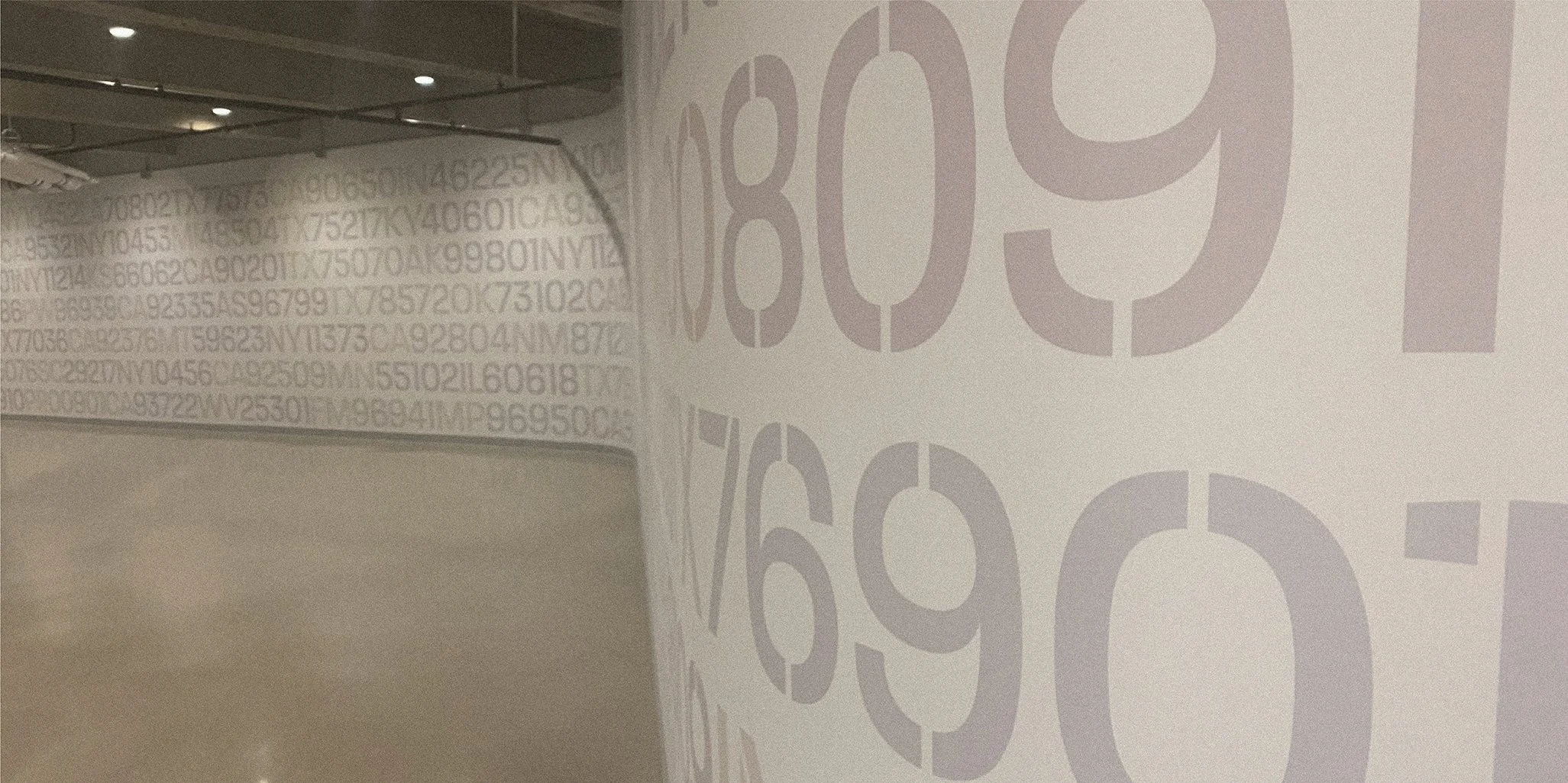 Interior of a store or warehouse with large numbers and quantities printed on the walls in bold font.