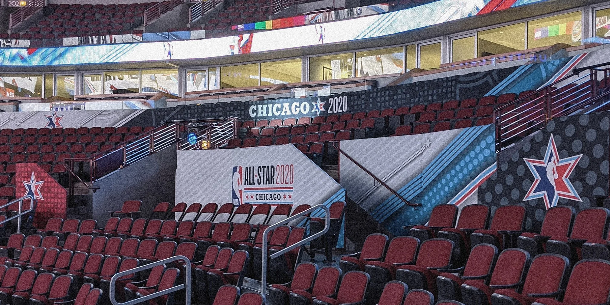 Empty seats and banners at the NBA All-Star 2020 event in Chicago, featuring the NBA logo, Chicago 2020 logo, and NBA All-Star 2020 signage in a sports arena.
