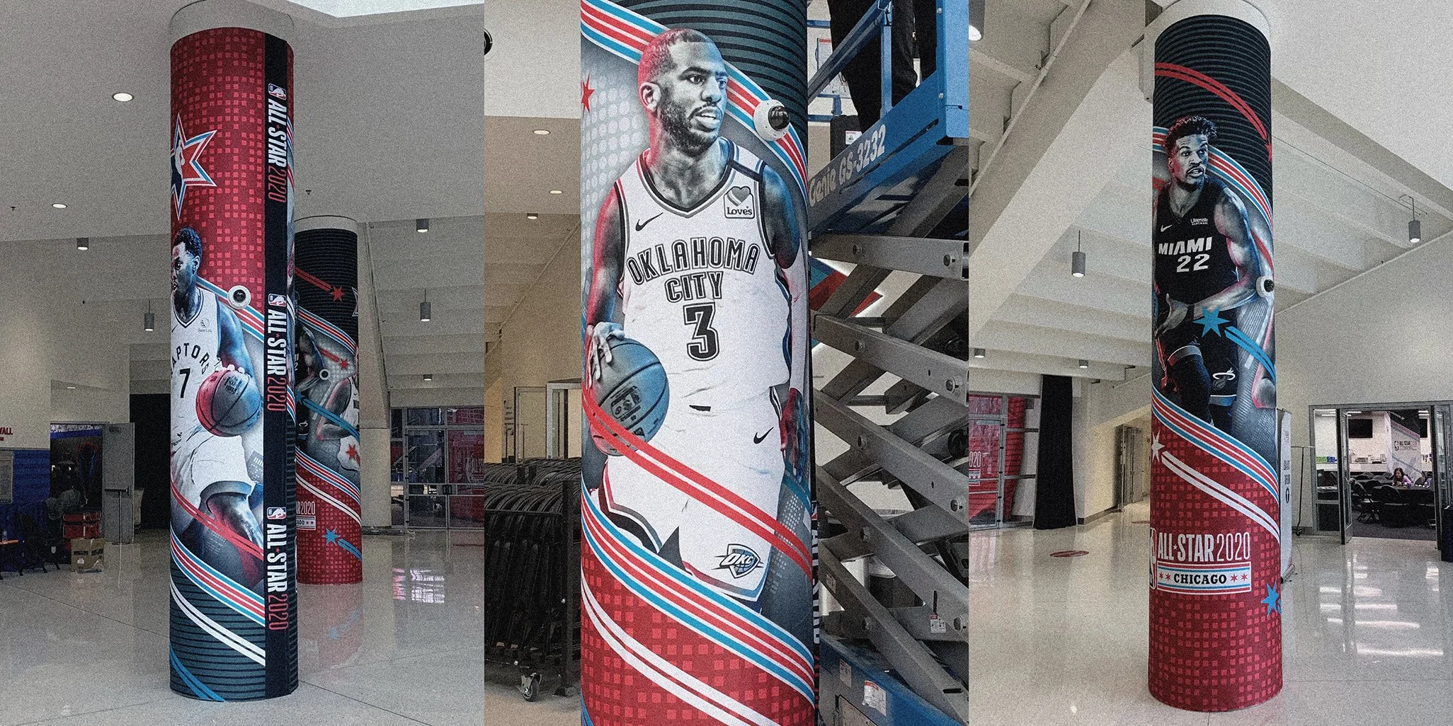 Three large columns with basketball player graphics and logos for the NBA All-Star 2020 event at Chicago. The columns feature images of players in action, with red, white, and blue themed designs and text.