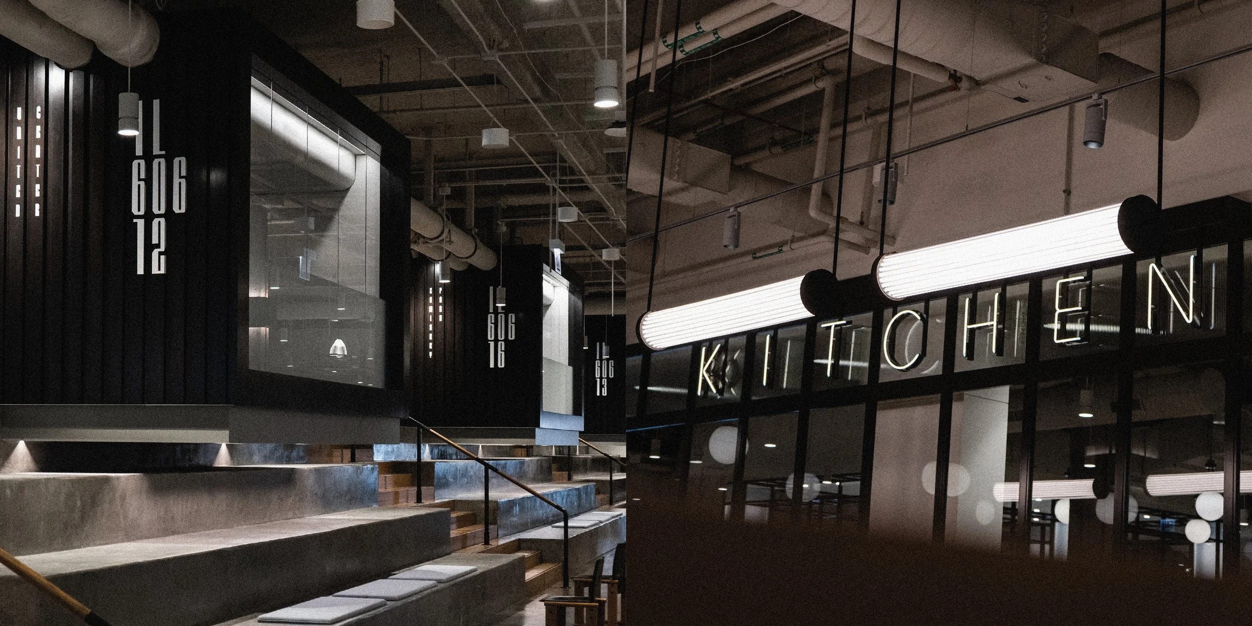 Interior of a modern kitchen with industrial design elements, concrete stairs, hanging lights, and black-framed glass partitions with the word 'KITCHEN' spelled out with illuminated letters.