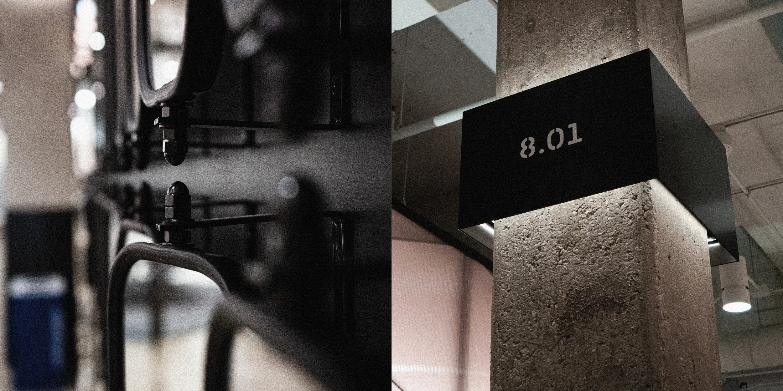 Close-up of metallic machinery parts on the left side and a black sign with white numbers 8.01 attached to a concrete pillar on the right side.