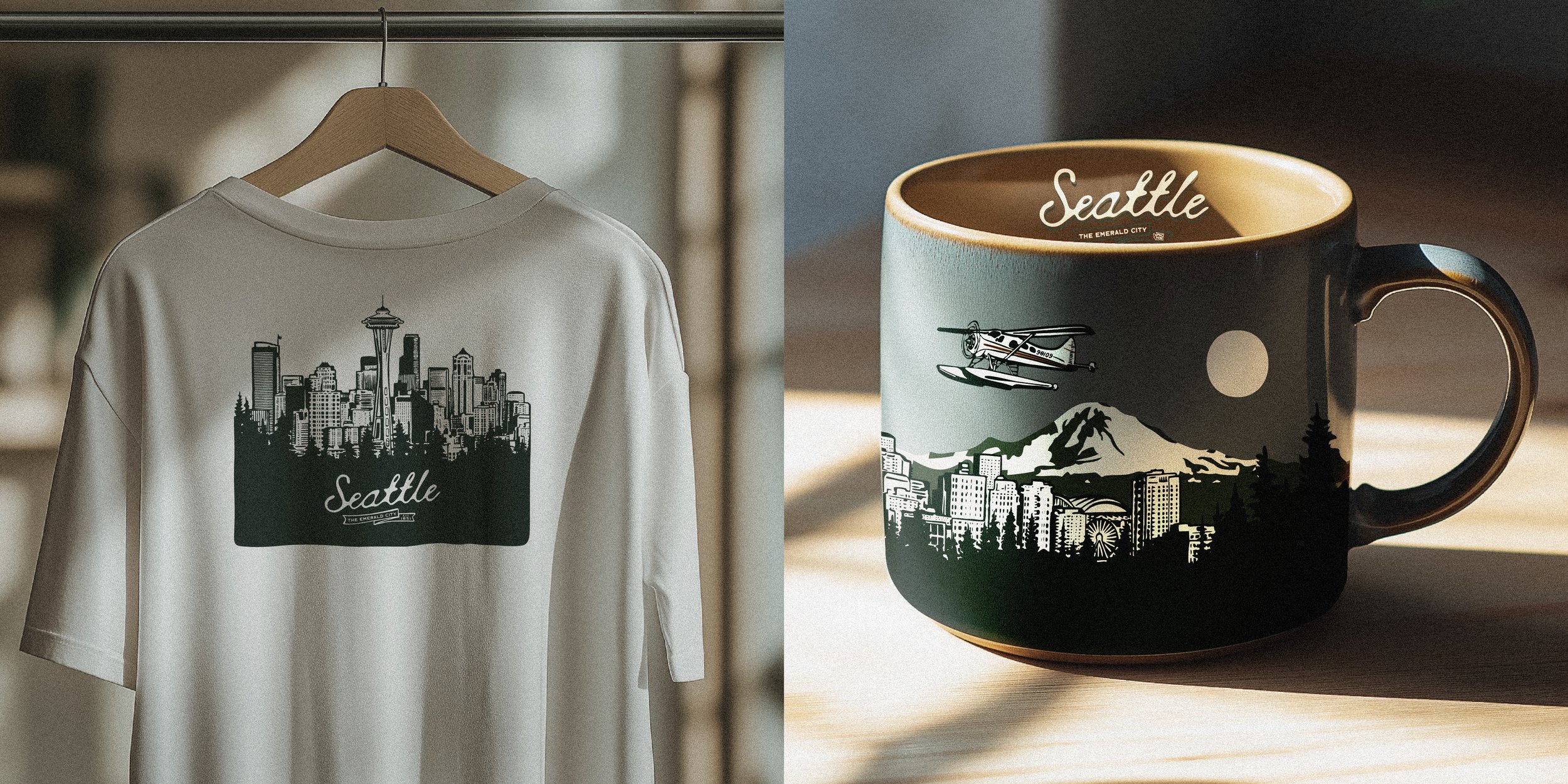 A white t-shirt and a mug with Seattle-themed illustrations. The t-shirt features a skyline with the Space Needle and the word 'Seattle'. The mug has a scene with Mount Rainier, a cityscape, a helicopter, a pagoda, and the word 'Seattle' written insi