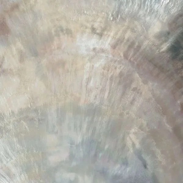 Close-up of a textured, curved concrete or stone surface.