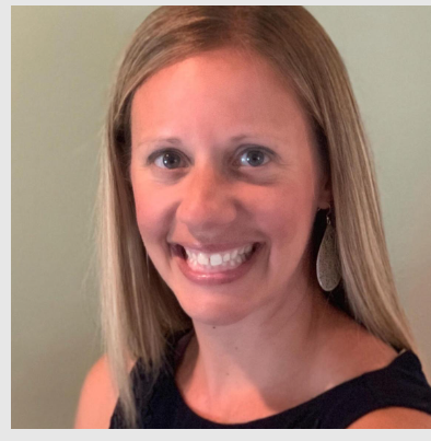 A woman smiling with long blonde hair, wearing earrings and a black top, against a light green background.