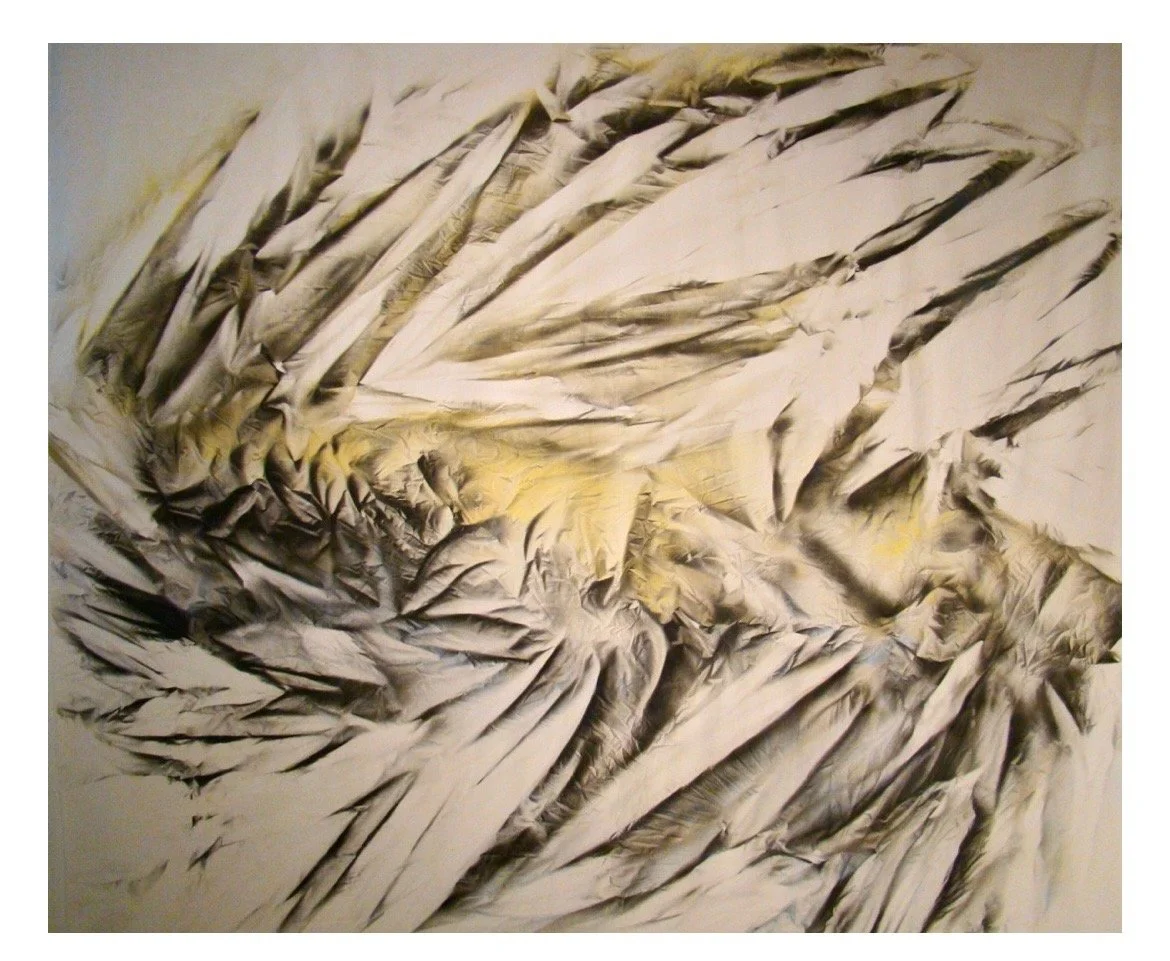 Close-up of crumpled newspapers with yellow and beige tones.