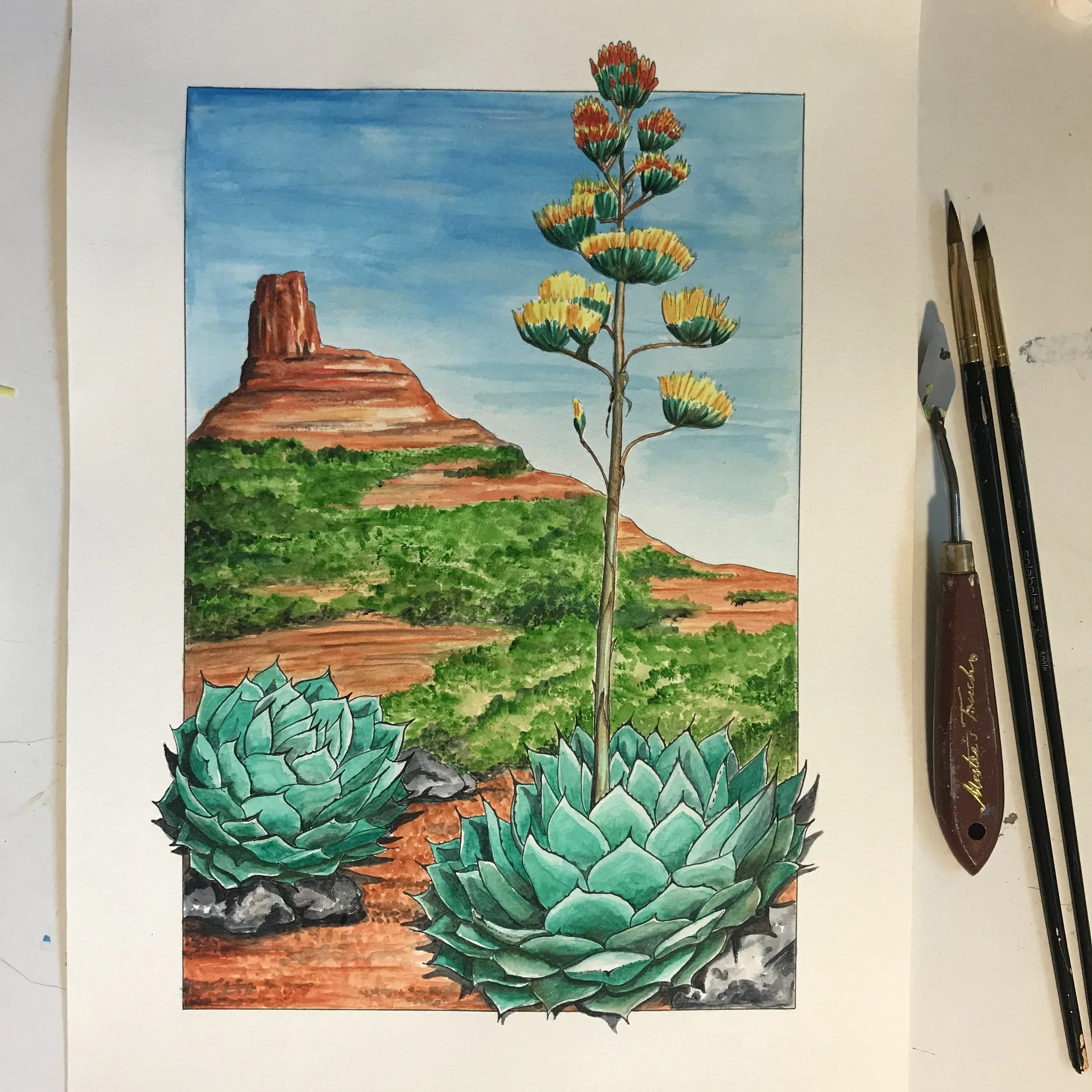Colorful watercolor painting of desert landscape with a tall agave plant, two smaller agave plants, a mountain, and a blue sky.