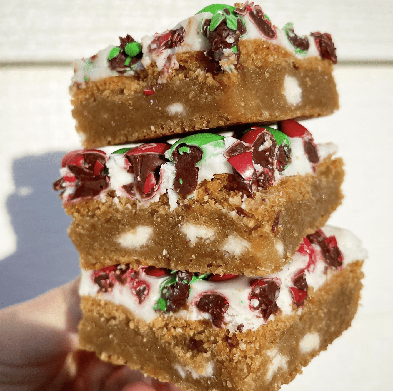 blondie bar stacked high with icing and m&ms