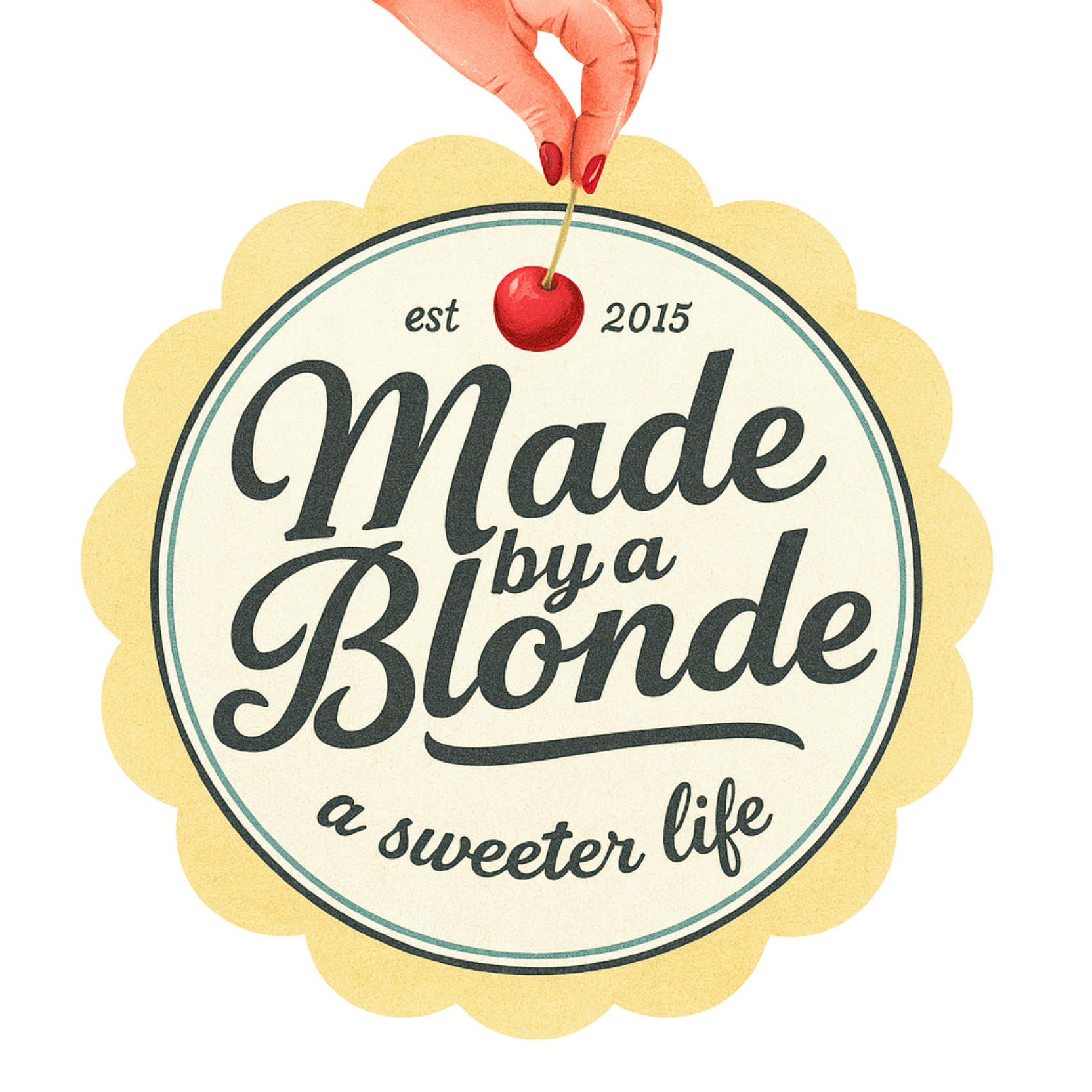 A circular badge with a scalloped edge and a beige background. It features the text "Made by a Blonde" in large, stylized script, with "a sweeter life" in smaller script below, and "est 2015" at the top. A hand with red fingernails is holding a cherry by its stem over the badge.