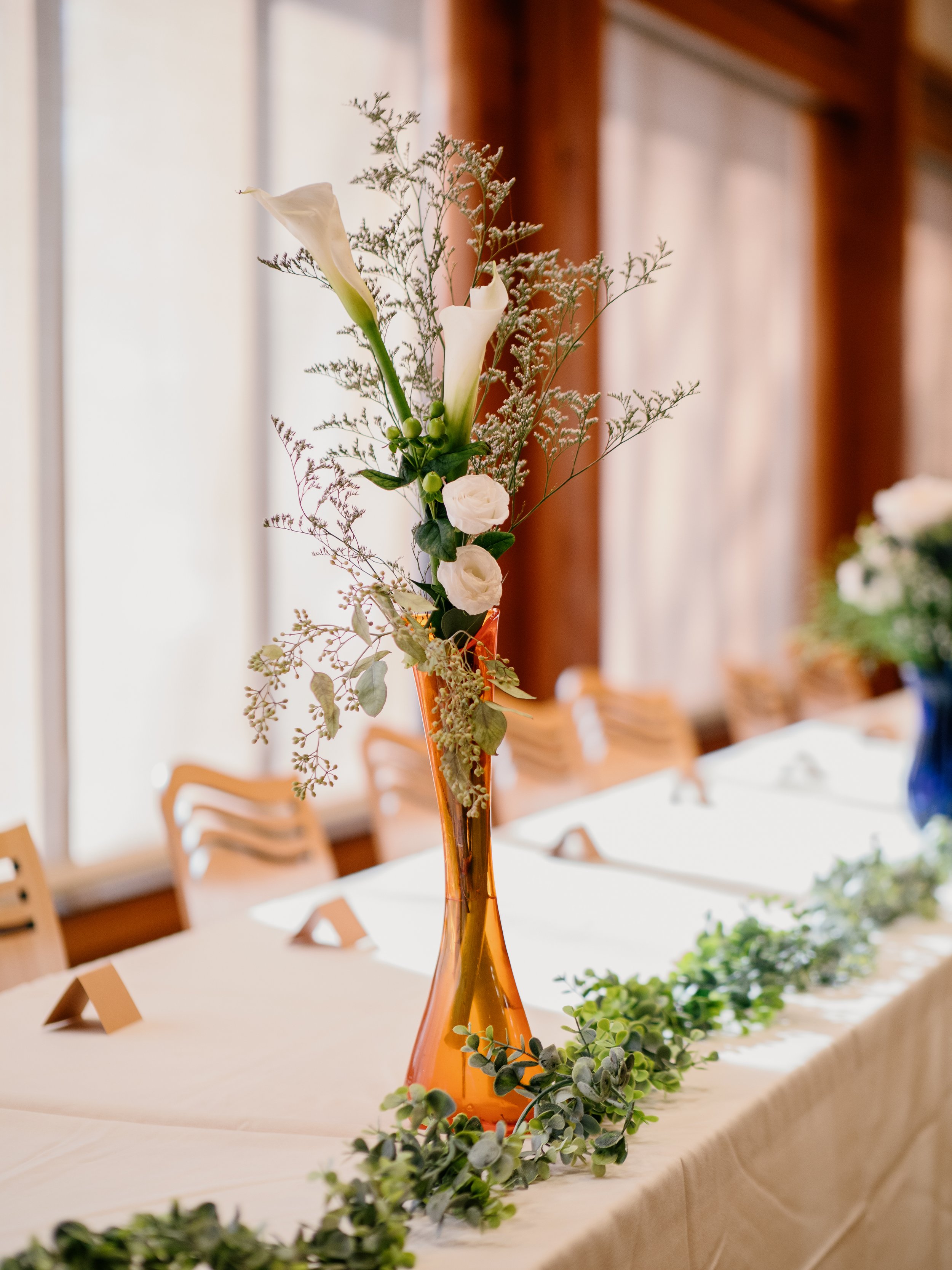 Reception décor detail from a formal winter wedding at Silverwood Park, Minneapolis — classic floral centerpiece wedding photography