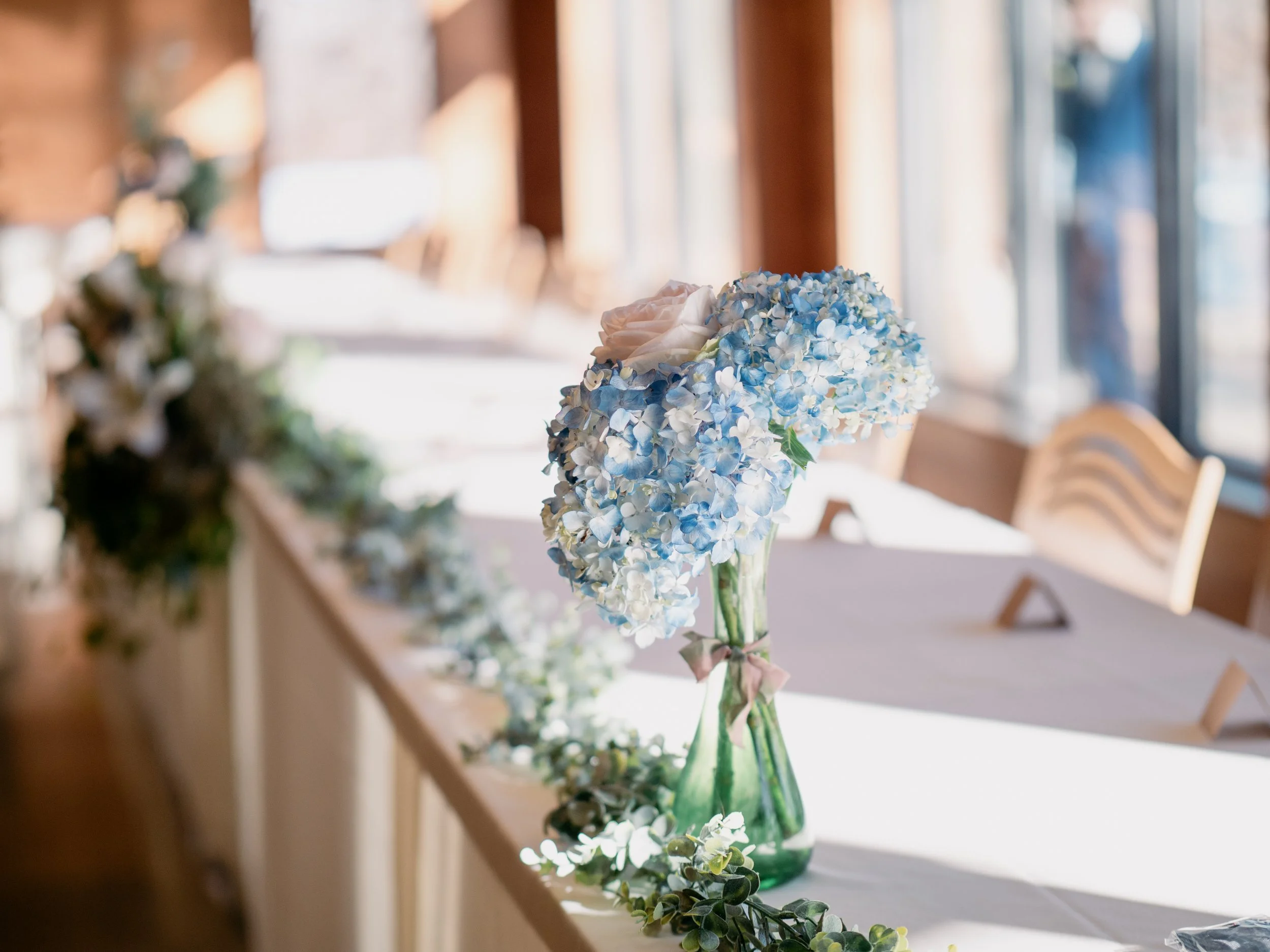 Reception décor detail from a formal winter wedding at Silverwood Park, Minneapolis — classic floral centerpiece wedding photography