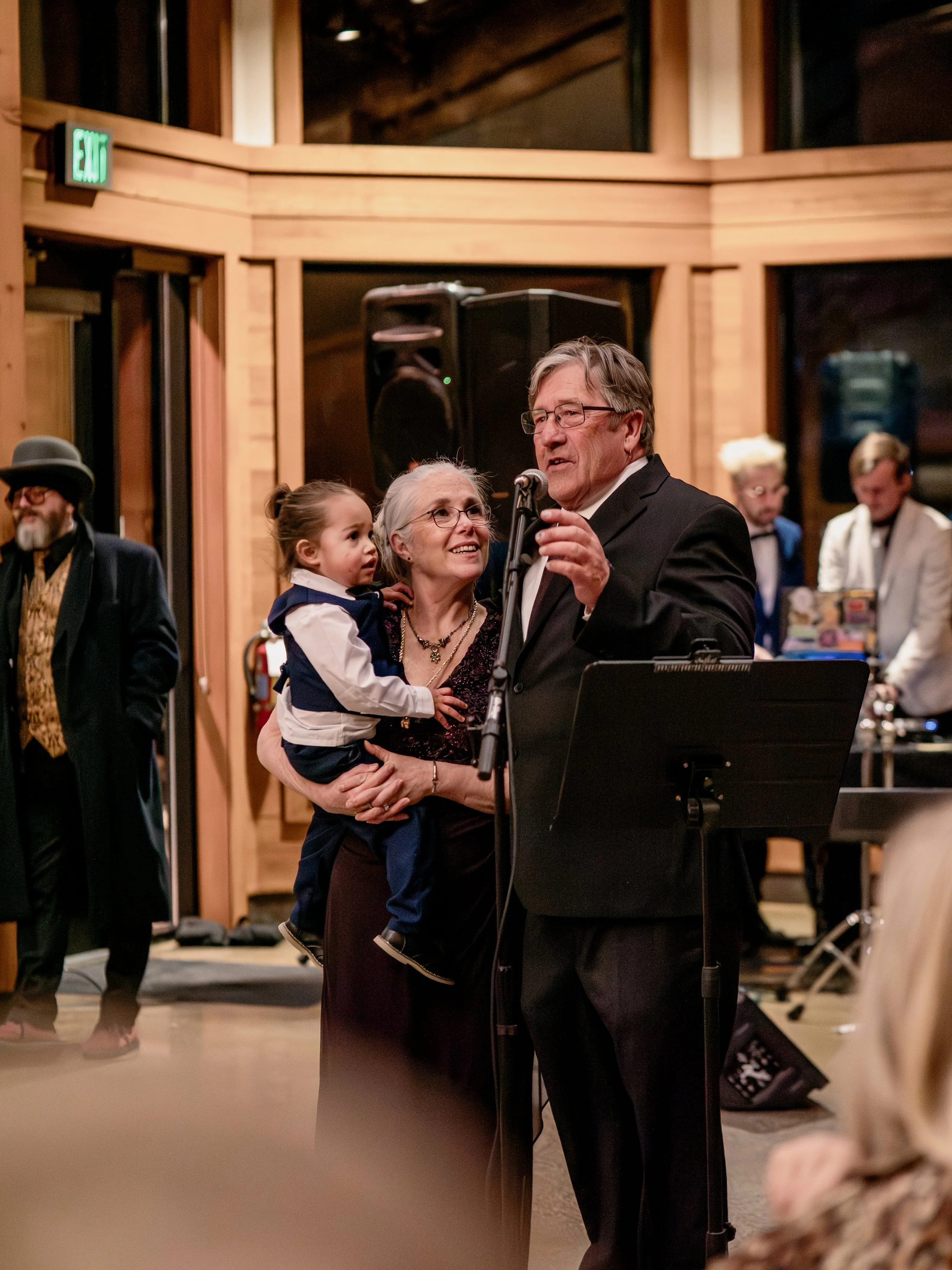 Wedding speech moment captured candidly at Hamil and Vanessa's classic winter wedding reception at Silverwood Park, Minneapolis