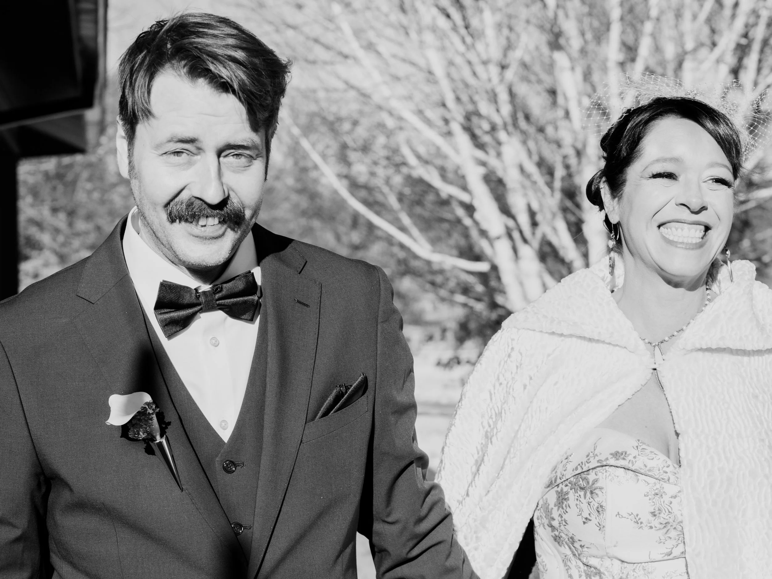 Hamil and Vanessa laughing together in a candid newlywed portrait at Silverwood Park, Minneapolis winter wedding