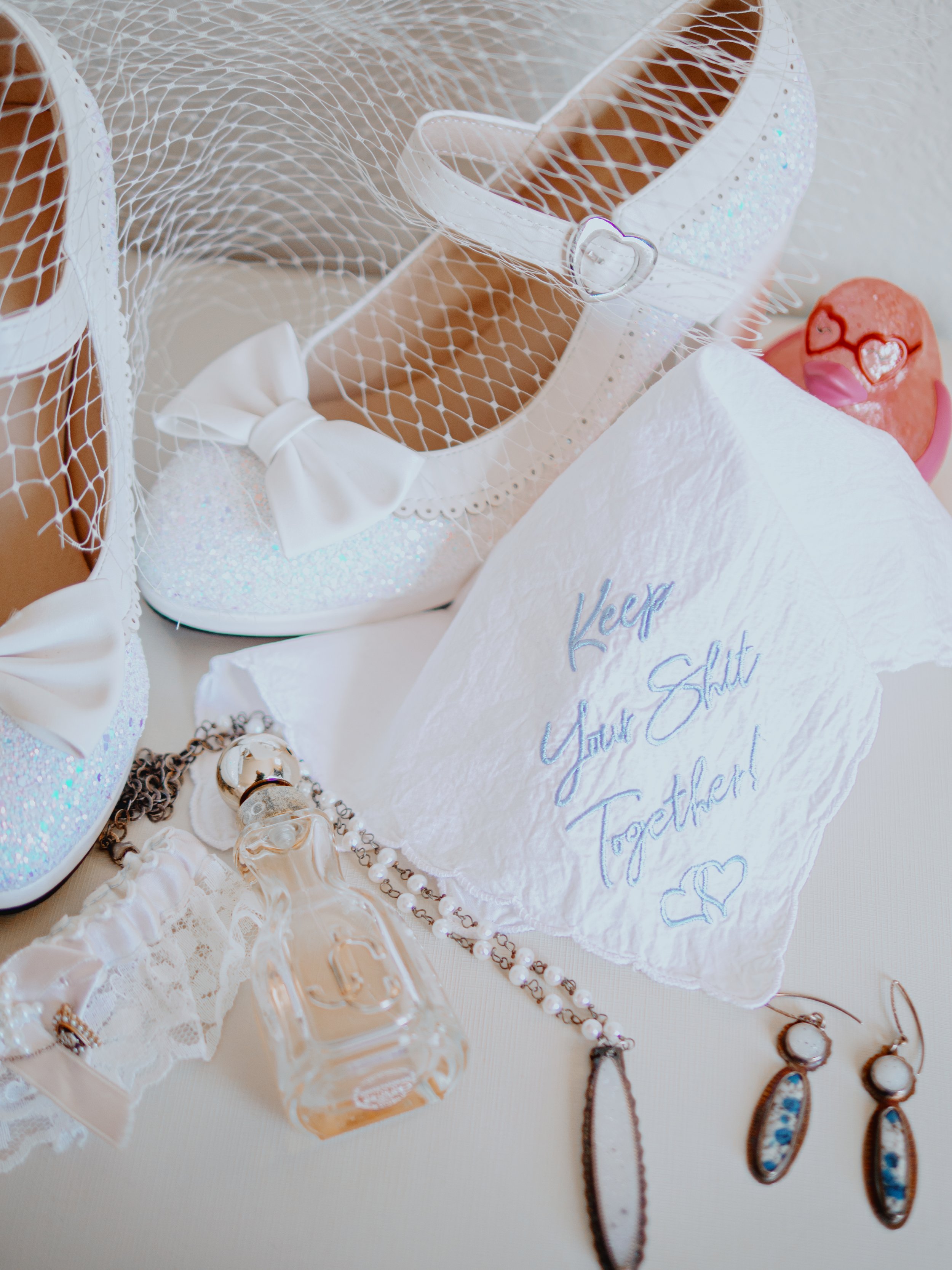 Close-up wedding detail photo of bridal accessories from Hamil and Vanessa's classic winter wedding at Silverwood Park, Minneapolis, Minnesota