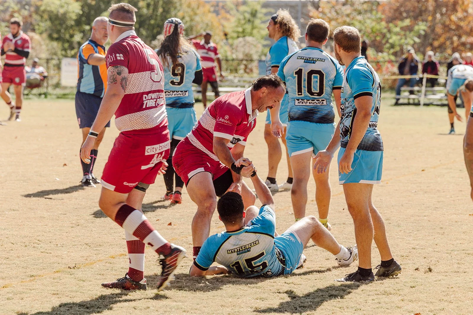 Asheville Men's Rugby member helps up opponent