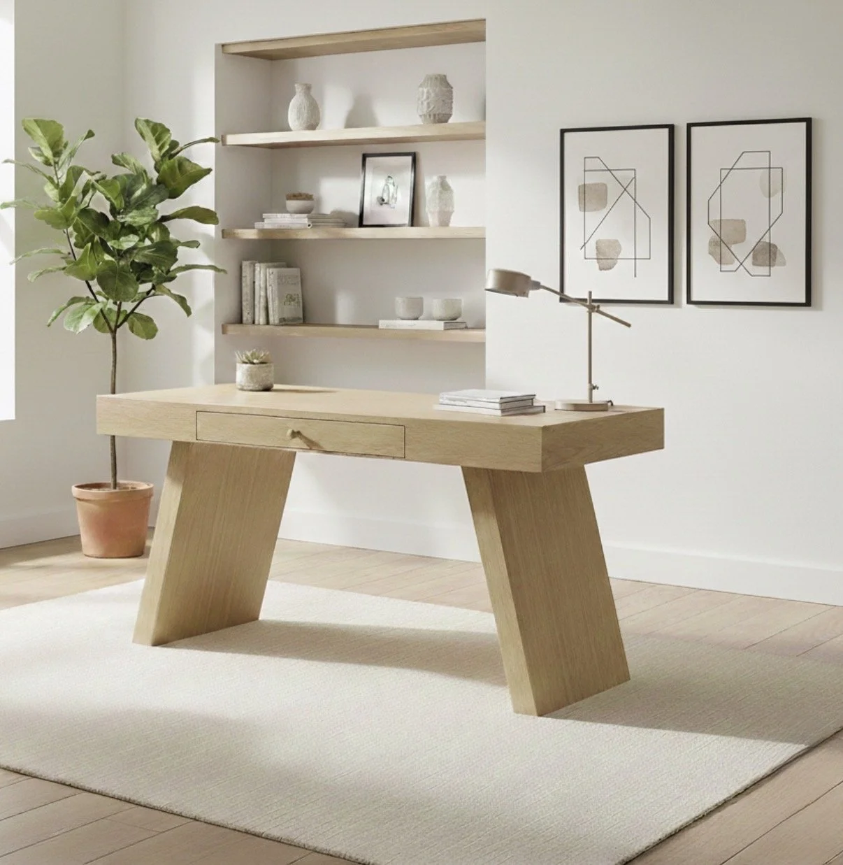 Minimalist home office with wooden desk, potted plant, wall art, and built-in shelves.