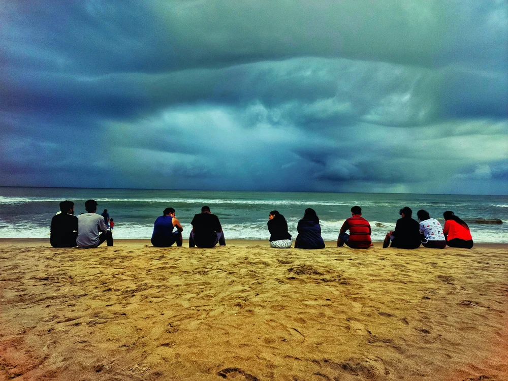 Faith group sitting together near the ocean
