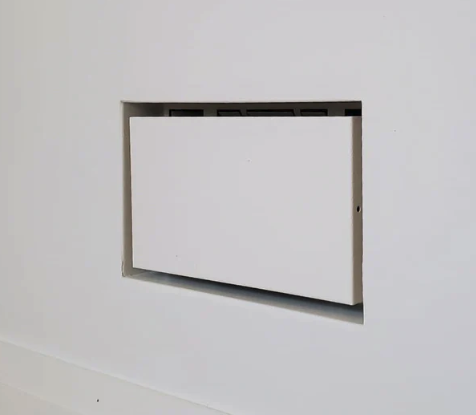 Wall-mounted white air vent cover on a plain white wall, aria vent, Fittes, flush vent, air return, drywall return, hidden, flat, register,
