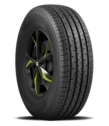 Close-up of a car tire with a black alloy wheel that has green accents.