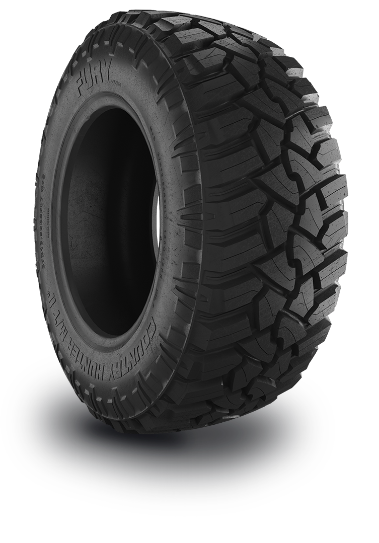 Close-up view of a black off-road tire with deep treads.