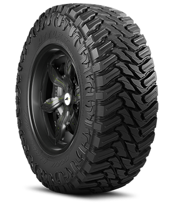 Close-up of an all-terrain tire mounted on a black wheel, showing deep treads and rugged design.