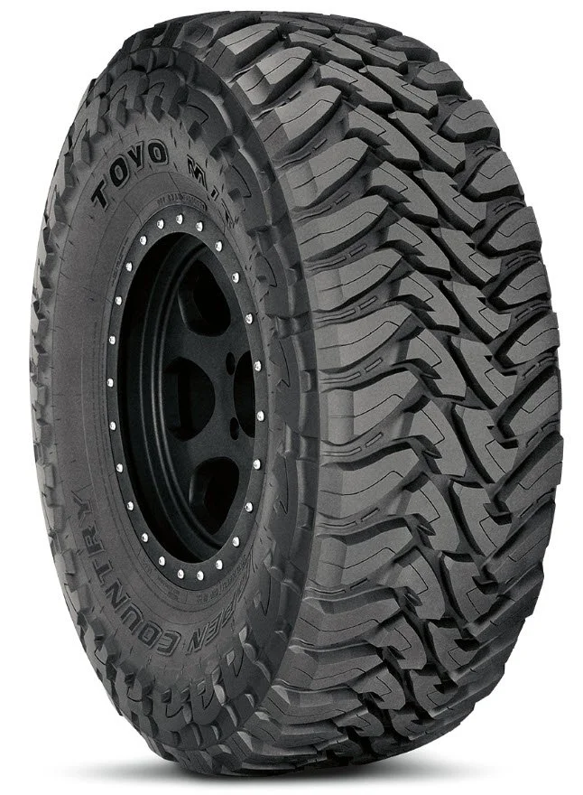 Off-road tire with deep treads for rugged terrain.