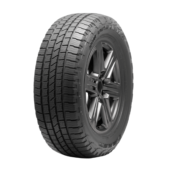 A black car tire with a detailed tread pattern and a dark gray alloy wheel.